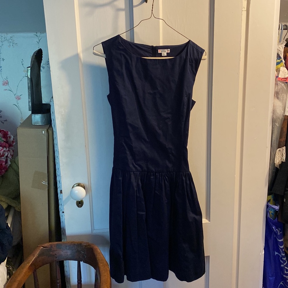 Cotton navy dress with a slight flare at the waist and ribbon belt.